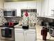 Cozy kitchen featuring modern appliances, white cabinets, tiled backsplash, and a stainless steel sink at 4209 E Hanna Ave, Tampa, FL 33610