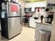 Functional kitchen with stainless steel appliances, white cabinets, a decorative backsplash, and ample counter space at 4209 E Hanna Ave, Tampa, FL 33610