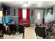 Comfortable living room featuring stylish seating, modern decor, a ceiling fan, and a decorative front door with stained glass at 4209 E Hanna Ave, Tampa, FL 33610