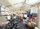 Interior of a storage shed filled with furniture, tires, and miscellaneous items; including a motorcycle at 4209 E Hanna Ave, Tampa, FL 33610