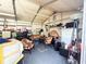 Interior of a cluttered storage shed featuring various items, including tires, furniture, and storage units at 4209 E Hanna Ave, Tampa, FL 33610