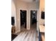 Hallway leading to a walk-in closet and Primary bedroom featuring luxury vinyl flooring and neutral color palate at 4217 Balington Dr, Valrico, FL 33596