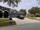 Charming home with a three car garage, well-manicured lawn, and a tree-lined street at 4217 Balington Dr, Valrico, FL 33596