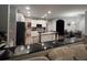 Bright, open kitchen featuring white cabinets, a large island with seating, and black stainless steel appliances at 4217 Balington Dr, Valrico, FL 33596
