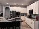 Elegant kitchen featuring white cabinets, stainless steel appliances, and granite countertops for a modern and functional space at 4217 Balington Dr, Valrico, FL 33596