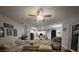 Spacious living room with a comfortable sofa, ceiling fan, and a view of the well-equipped kitchen and dining area at 4217 Balington Dr, Valrico, FL 33596