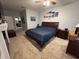 Bright bedroom with a king-size bed, soft carpeting, and artwork, offering a comfortable and stylish retreat at 4217 Balington Dr, Valrico, FL 33596