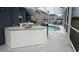 Screened in outdoor kitchen with countertop, grill and sink overlooking the pool at 4217 Balington Dr, Valrico, FL 33596