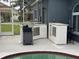 Poolside outdoor kitchen with stainless steel grill, built-in cabinets, and sink at 4217 Balington Dr, Valrico, FL 33596
