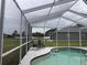 Screened-in pool area with pool, lounge chairs, and lighting for evening enjoyment at 4217 Balington Dr, Valrico, FL 33596