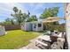Inviting backyard featuring a putting green, outdoor seating, and lush landscaping, perfect for relaxation at 5315 40Th N St, St Petersburg, FL 33714