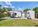 Backyard with pool, basketball hoop, outdoor lounge area, putting green, patio, and lawn at 5315 40Th N St, St Petersburg, FL 33714