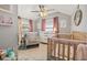 Cozy Bedroom with a rocking chair, crib, and soft pink accents, creating a warm and inviting space at 5315 40Th N St, St Petersburg, FL 33714