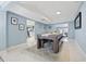 Open-concept game room area featuring sleek marble floors and easy access to the kitchen at 5315 40Th N St, St Petersburg, FL 33714