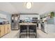 Charming kitchen featuring white cabinets, stainless steel appliances and a kitchen island at 5315 40Th N St, St Petersburg, FL 33714