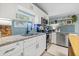 Updated kitchen with white cabinetry, stainless appliances, and blue backsplash at 5315 40Th N St, St Petersburg, FL 33714