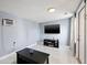 Bright room with a TV, media stand, modern tile floors, and A/C unit at 5315 40Th N St, St Petersburg, FL 33714