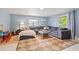 Bright living room featuring a large sectional sofa, a cozy rug, and ample natural light from the windows at 5315 40Th N St, St Petersburg, FL 33714