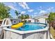 An above-ground pool is surrounded by buildings and trees in this backyard at 5315 40Th N St, St Petersburg, FL 33714