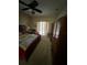 Cozy bedroom featuring neutral colors, a ceiling fan, and access to an outdoor area at 5811 White Oak Bayou Ct, Bradenton, FL 34203