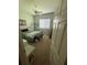 Cozy bedroom with a ceiling fan, comfortable bed, and a bright window view at 5811 White Oak Bayou Ct, Bradenton, FL 34203