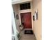 Charming entryway featuring a red front door, decorative accents, and a welcome mat at 5811 White Oak Bayou Ct, Bradenton, FL 34203