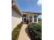 Inviting front entrance with brick walkway surrounded by lush landscaping and mature shrubs at 5811 White Oak Bayou Ct, Bradenton, FL 34203