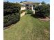 Attractive landscaping with lush green lawn and shrubs leads to the front entrance of this home at 5811 White Oak Bayou Ct, Bradenton, FL 34203