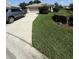 Well-manicured front yard with lush green lawn, mature landscaping, and a two-car garage at 5811 White Oak Bayou Ct, Bradenton, FL 34203
