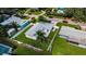 An aerial view of the home, highlighting its fenced yard and well-manicured lawn at 717 Pinewood Dr, Dunedin, FL 34698