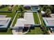 An aerial view of the home showcasing the fenced yard and mature landscaping at 717 Pinewood Dr, Dunedin, FL 34698