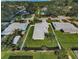 This aerial shot showcases the home's well-maintained yard and neighborhood setting at 717 Pinewood Dr, Dunedin, FL 34698