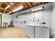 Basement featuring a washer, a dryer, shelving, and an unfinished floor, providing ample storage space at 717 Pinewood Dr, Dunedin, FL 34698