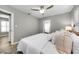 Comfortable bedroom featuring a neutral color palette, soft lighting, and access to an en-suite bathroom at 717 Pinewood Dr, Dunedin, FL 34698