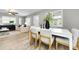 Cozy dining area featuring natural light and a seamless transition to the living room at 717 Pinewood Dr, Dunedin, FL 34698