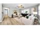 Inviting living room with modern decor, hardwood floors, a ceiling fan and access to other rooms at 717 Pinewood Dr, Dunedin, FL 34698