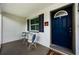 Charming front porch with a cozy seating area, perfect for relaxing outdoors at 717 Pinewood Dr, Dunedin, FL 34698