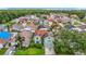 View of the neighborhood featuring a two-story house with solar panels, landscaping, and a two-car garage at 9707 Kings Canyon Pl, Tampa, FL 33634