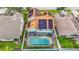 Aerial view of backyard pool, solar panels and covered patio at 9707 Kings Canyon Pl, Tampa, FL 33634