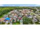 Neighborhood shot showcasing a home with a well maintained lawn, lush trees and a community lake at 9707 Kings Canyon Pl, Tampa, FL 33634
