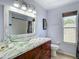 Bathroom featuring a clear glass bowl sink, marble countertop, and wooden vanity at 9707 Kings Canyon Pl, Tampa, FL 33634