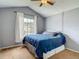 Cozy bedroom featuring a vaulted ceiling, ceiling fan, and a bright window for natural light at 9707 Kings Canyon Pl, Tampa, FL 33634
