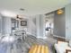 Open-concept dining room with gray walls, stairs to the second floor, and direct access to the living room at 9707 Kings Canyon Pl, Tampa, FL 33634