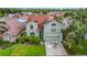 Charming two-story home with a well-maintained lawn, mature landscaping, and inviting curb appeal at 9707 Kings Canyon Pl, Tampa, FL 33634
