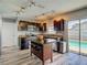 Modern kitchen features stainless steel appliances, dark cabinetry, an island, and easy access to the outdoor pool at 9707 Kings Canyon Pl, Tampa, FL 33634