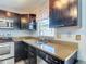 Kitchen featuring stainless steel appliances, modern sink and faucet, granite countertops, and dark brown cabinetry at 9707 Kings Canyon Pl, Tampa, FL 33634