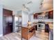 Modern kitchen with stainless steel appliances, wood floors, and a center island at 9707 Kings Canyon Pl, Tampa, FL 33634