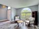 Bright living room with seating area, light gray walls, and wood floors at 9707 Kings Canyon Pl, Tampa, FL 33634