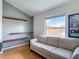 Living room with three-seater couch, wood floors and modern wall shelving at 9707 Kings Canyon Pl, Tampa, FL 33634