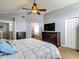 Bedroom featuring an ensuite bathroom, two dressers and vaulted ceilings at 9707 Kings Canyon Pl, Tampa, FL 33634